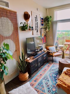 a living room filled with furniture and a flat screen tv sitting on top of a wooden table