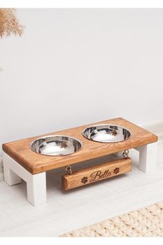 a dog bowl stand with two bowls on it