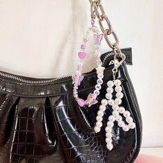 Bag charms are perfect for decorating your purse inspired by the Birkin style. Use it in tote bags, backpacks, and more. Get a girly purse this season. Do a girl's night with your best friends and style your favorite bag. 1. Purple name chain 2. Pearl bow chain Sizes: bow 6 x 7 inch personalized purple name chain 9.5 inch  This order is just ONE bag jewelry style. The purse doesn't come in the order. Only the 2nd style can be personalized. Accessorizing Bags, Girly Purse, Bag Accessories Keychain, Birkin Style, Bag Styling, Purple Names, Bow Keychain, Purse Decorations, Accessorize Bags