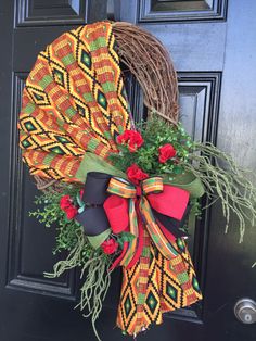 a wreath on the front door is decorated with flowers