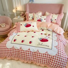 a bed with red and white checkered bedspread, pillows and pillow cases