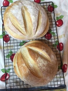 two loaves of bread sitting on top of a cooling rack