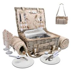 a wicker picnic basket with utensils and silverware