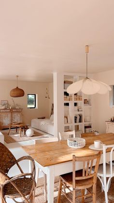 a dining room table with chairs and a television in the backround next to it