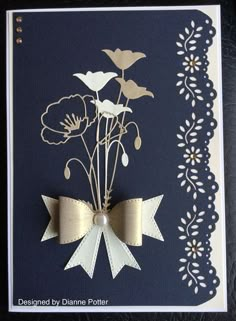 a card with flowers on it and a ribbon attached to the back of it,