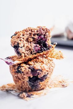 two blueberry muffins stacked on top of each other