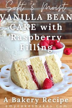 vanilla bean cake with raspberry filling on a white platter next to fresh raspberries