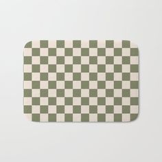 a green and white checkerboard pattern bath mat