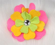 a pink, yellow and green flower brooch