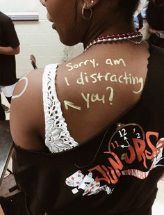 a woman with writing on her back that says sorry, am i distracting you