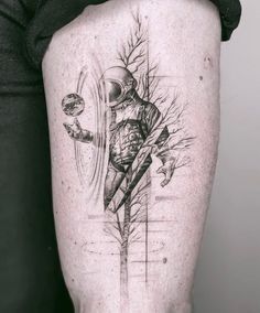 a man's leg with a tattoo on it that has an image of a person holding