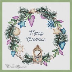 a cross stitch christmas card with a birdhouse in the center and holly wreath around it