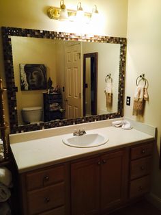 a bathroom sink sitting under a large mirror