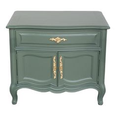 a green dresser with gold trimmings on the top and bottom drawers, against a white background