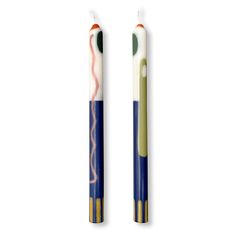 two toothbrushes sitting next to each other on a white surface