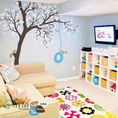 a child's playroom with a tree painted on the wall