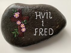 a rock with flowers painted on it that says hyil i fried