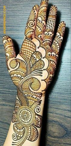 a woman's hand is decorated with hennap and intricate designs on it