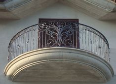 a balcony with wrought iron balconies and a window