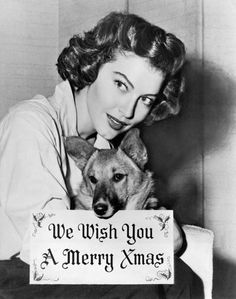 a woman holding a sign that says, we wish you a merry christmas