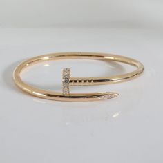 This is part of Chairish’s Fine Jewelry assortment.  Cartier Juste Un Clou Bracelet in 18k Yellow Gold 0.58 CTW   PRIMARY DETAILS   SKU: 140438   Listing Title: Cartier Juste Un Clou Bracelet in 18k Yellow Gold 0.58 CTW   Condition Description: Translating to 'just a nail', the Juste Un Clou collection from Cartier is one of the Maison's most celebrated styles. The collection was born in the '70s and represented the brand's edgier side and flair for unique design.       Retails for 13300 USD. In excellent condition and recently polished. 16 cm in length. Comes with Box;Certificate of Authenticity;   Brand: Cartier   Collection/Series: Juste Un Clou   Metal Type: Yellow Gold   Metal Purity: 18k   Chain or Bracelet Length (in): 16   Pre-Owned Jewelry Condition: Excellent   SIDE STONE INFORMA Cartier Jubilee Gold Bracelet, Cartier Diamond Accents Bracelet Jewelry, Cartier Fine Jewelry Bracelet With Diamond Accents, Cartier 14k Gold Bracelet Gift, Cartier Gold Bangle With 17 Jewels, Designer Cartier Gold Bracelets, Gold Cartier Diamond Bracelet With 17 Jewels, Designer Gold Cartier Bracelet, Luxury Snake-shaped Jewelry With Diamond Accents