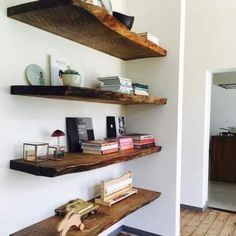 two wooden shelves with books and other items on them