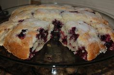 a cake that has been cut in half and is on a glass platter with one slice taken out