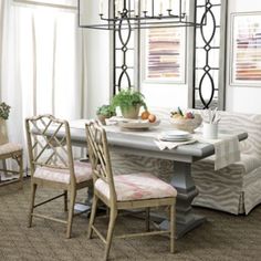 a dining room table with four chairs around it