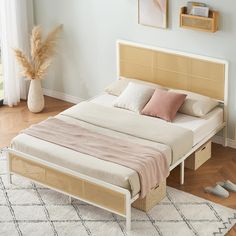 a bed sitting on top of a wooden floor next to a white rug and window