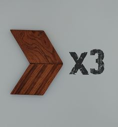 the letters c and x are made out of wood, with an arrow in the middle