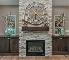 a large clock mounted to the side of a wall above a fire place in a living room