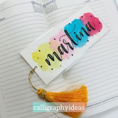 a bookmark with the word mama written on it next to an open notebook and tassel