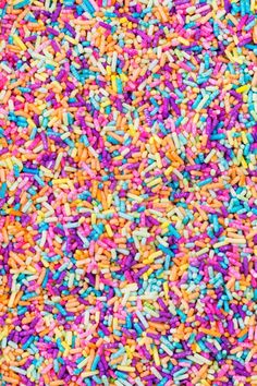 colorful sprinkles are scattered on top of each other