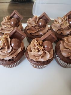 cupcakes with chocolate frosting and gold decorations