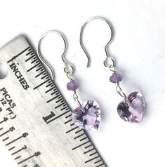 "Are you ready for Valentine's Day? These are perfect little heart earrings for your loved one. The stones are a high quality with a lovely purple hue and very clear without inclusions. Each earring is 1\" inch in length. Each amethyst heart is 10mm." Handmade Purple Heart Earrings For Valentine's Day, Trendy Purple Heart Earrings, Purple Heart Charm Earrings For Valentine's Day, Handmade Purple Heart-shaped Jewelry, Purple Heart-shaped Pierced Earrings, Purple Heart Earrings, Purple Heart, Purple Hues, Heart Earrings