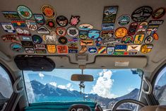 the inside of a vehicle with many stickers on it's ceiling and dashboard