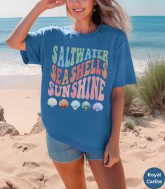 🌊Discover our Retro Summer Beach, Saltwater, Seashells, Sunshine Comfort Colors shirt!🏝️ This trendy unisex t-shirt is designed to enhance your beach vibes and have you dreaming of your next beach vacation! Featuring an eye-catching vintage design, this shirt is super soft and comfortable made of 100% ring-spun ethically grown cotton. It has a relaxed fit that is made of a medium fabric that is preshrunk. Looks super cute with shirts, jeans or size up for an oversized beach cover up. Great gif Casual Pre-shrunk T-shirt For Beach, Fun Beach Tops For Vacation, Fun Beach Vacation Tops, Casual Ocean Color Beach Tops, Casual Ocean Color Tops For Beach, Pre-shrunk Summer T-shirt For The Beach, Casual Blue T-shirt For Beach Party, Fun Beach Tops With Funny Print, Summer Blue T-shirt For Vacation