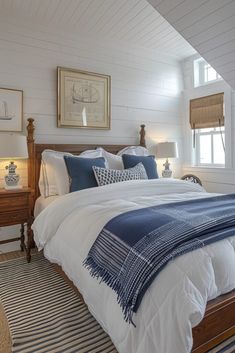 a bed with blue and white pillows in a bedroom