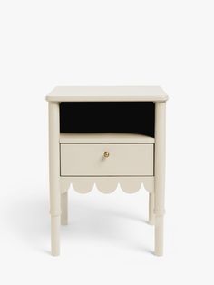 a white table with a black drawer on it's top and an open drawer in the middle