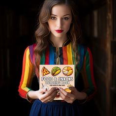 a woman holding up a book with food and snacks on it in front of her face