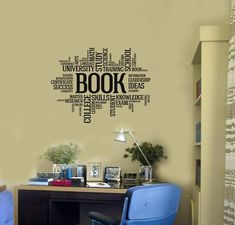 a room with a desk, chair and book wall decal on the wall above it