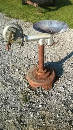 an old rusty fire hydrant sitting on top of gravel