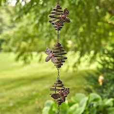 a wind chime hanging from a tree in a park