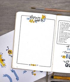 an open notebook with writing on it next to pencils and paper workbook pages