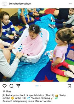 a group of children sitting on the floor playing with an inflatable bathtub