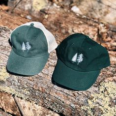 Our White Pine and Spruce Washed Chino Hat is the perfect adventure and hiking hat. Depicting two of Maine’s most iconic trees, this tree hat is perfect for any forest lover. Made for men and women. Dad Cap: 100% cotton garment-washed twill - adjustable tri-glide buckle closure Trucker Cap: Pigment Dyed - 55/45 cotton/polyester, mesh with snap back closure Embroidered Locally Unstructured, six-panel, low-profile Winter Six-panel Hat For Outdoor Activities, Cotton Baseball Cap For Hiking, Cotton Trucker Hat For Outdoor Activities, Cotton Snapback Trucker Hat For Outdoor Activities, Green Cotton Baseball Cap For Outdoor Activities, Cotton Cap For Hiking, Cotton Hiking Cap, Adjustable Trucker Hat For Winter Outdoor Activities, Adjustable Cotton Trucker Hat For Camping