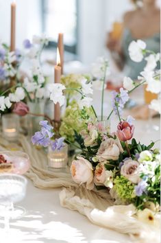 the table is set with flowers and candles for an elegant wedding breakfast or brunch