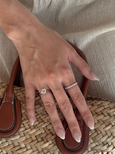 a woman's hand on top of a basket with her nails in the middle