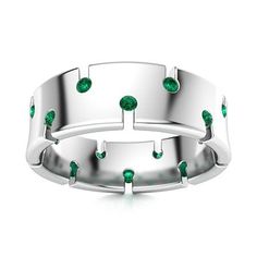 a white gold ring with green stones