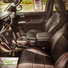 the interior of a car with black leather seats